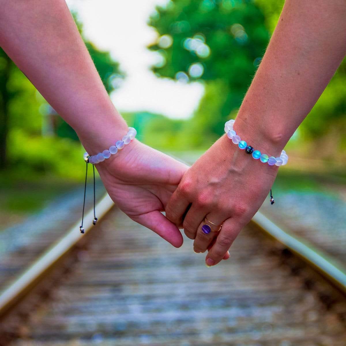 White Mermaid Glass Distance Bracelets With Models Holding Hands