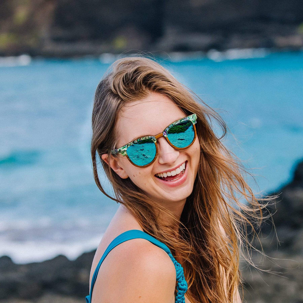 Smiling Woman Wearing Wooden Beachcomber Sunglasses At The Beach