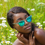 Model Wearing Beachcomber Ice Blue Wooden Abalone Sunglasses In The Meadow