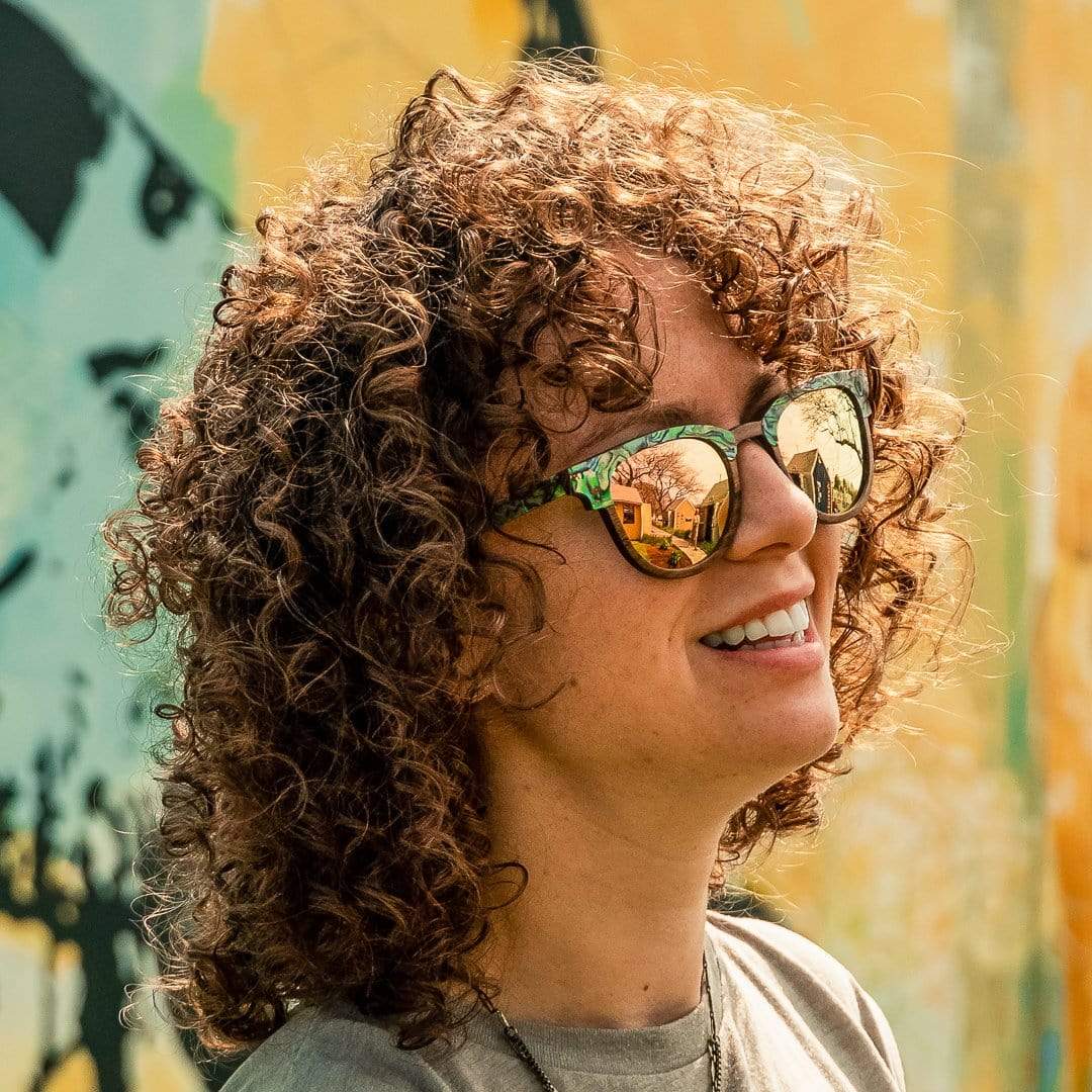 Model With Curly Hair Is Wearing Beachcomber Abalone Seashell Wooden Sunglasses With Rose Lenses 