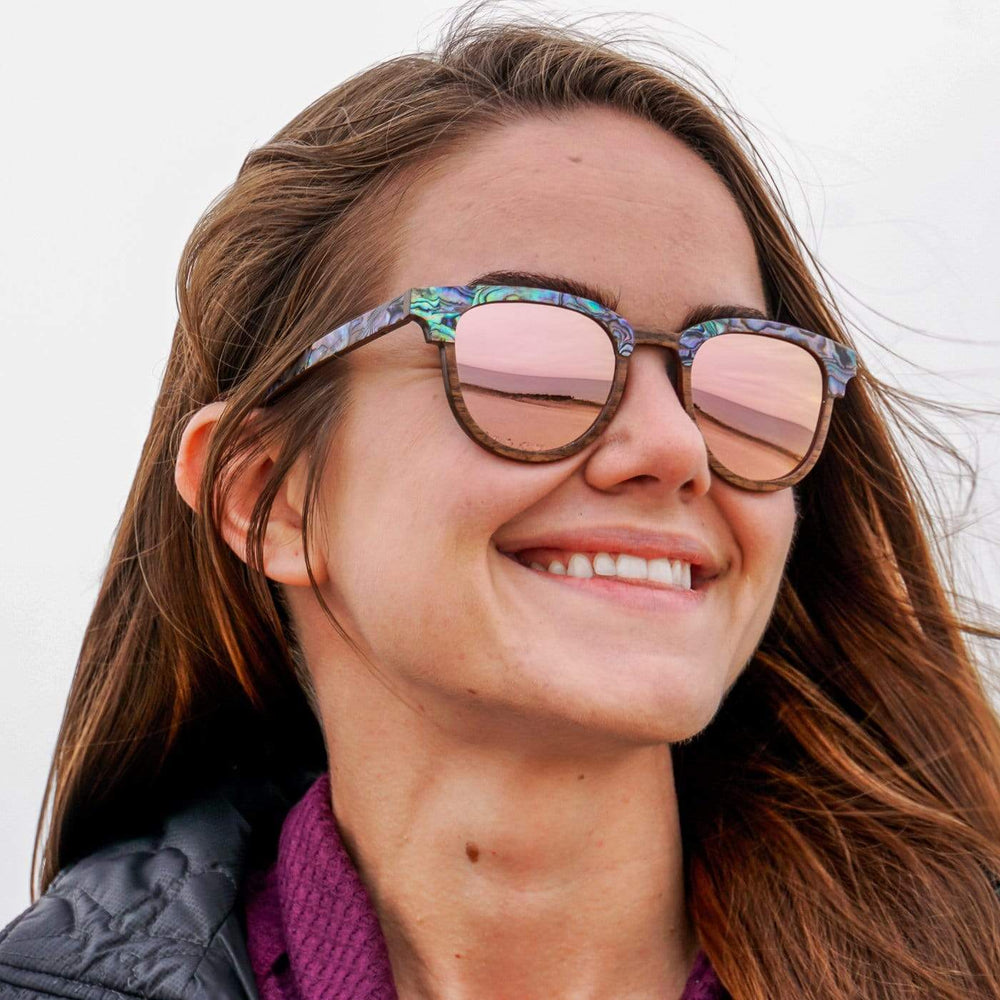 Smiling Woman Wearing Beachcomber Abalone Seashell Wooden Sunglasses With Rose Lenses