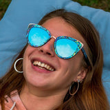 Laughing Woman Wearing Wooden Bombshell Abalone Seashell Sunglasses With Ice Blue Lenses