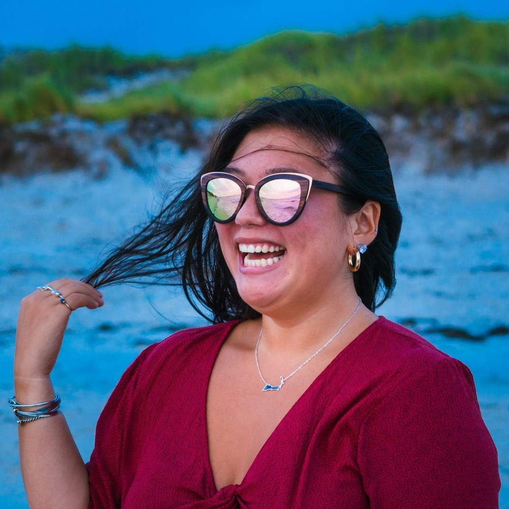 Smiling Woman Wearing Wooden Bombshell Sunglasses With Rose Lenses 