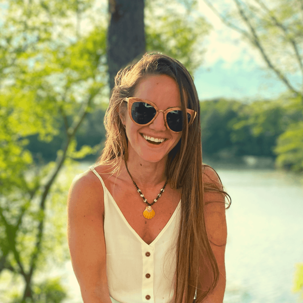 Model Wearing Wooden Bombshell Sunglasses With Smoke Lenses At A Lake 