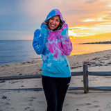 Female Model At The Beach Wearing A Cotton Candy Cloud Blend Hoodie From SLYK 