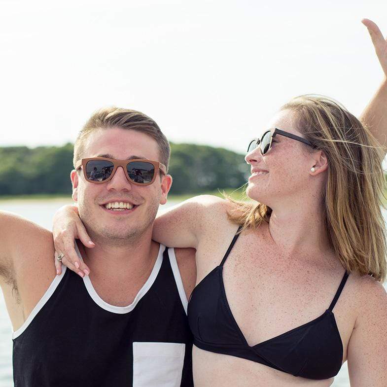 Male Model Wearing Brown Maple Wood Floating Drifter Sunglasses At The Lake